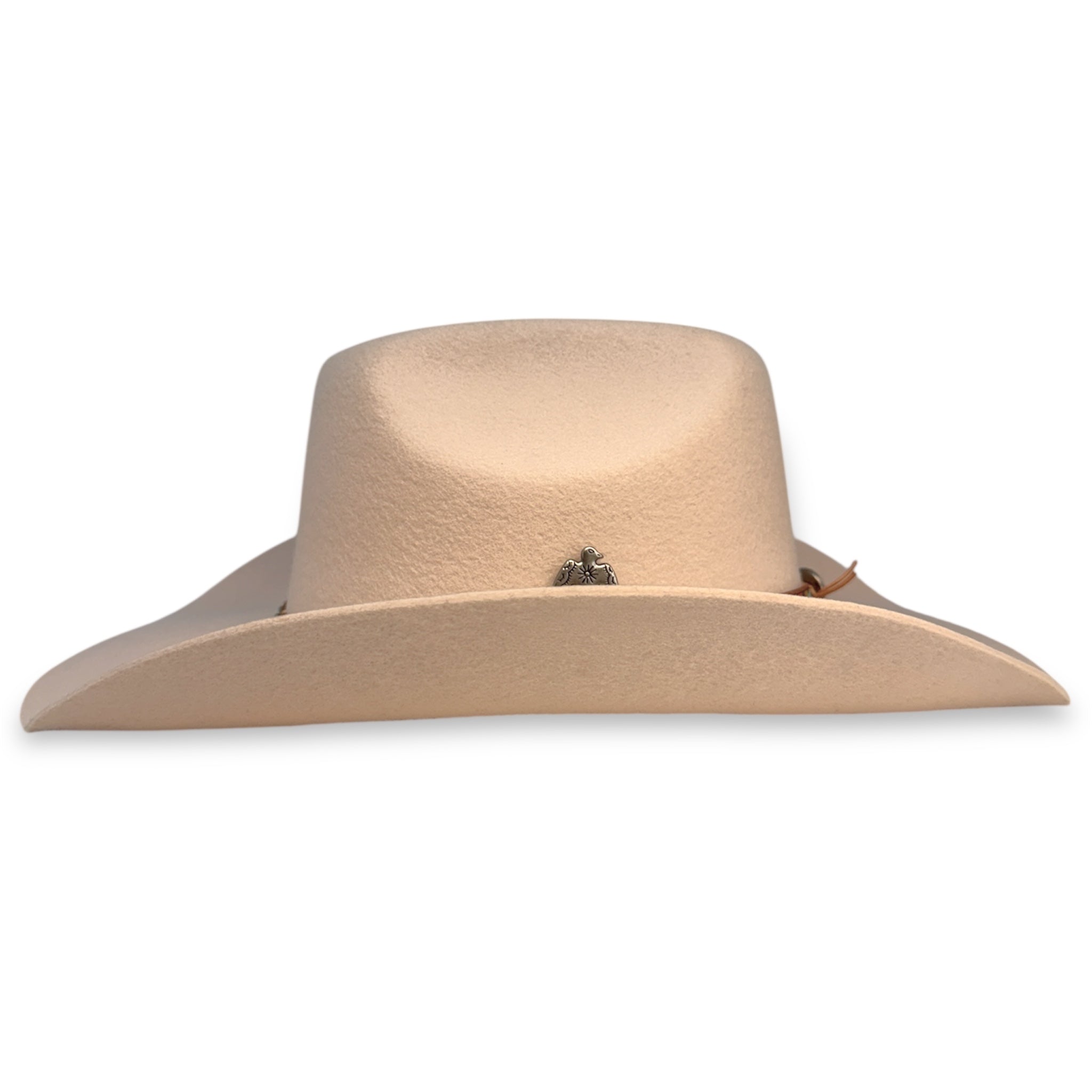 Side view of beige felt cowboy hat showing the wings of the hat, and the silver thunderbird concho.
