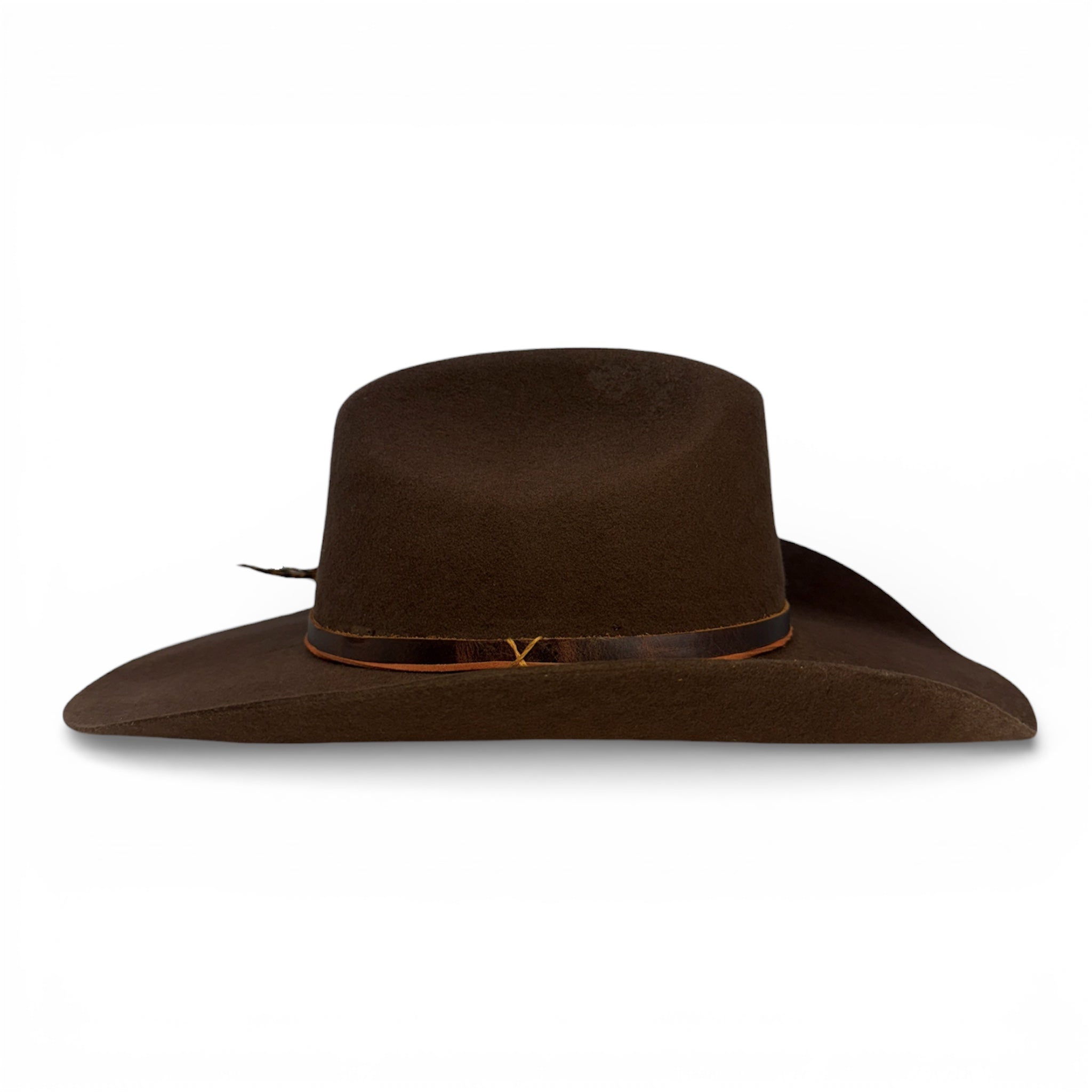 Opposite side view of a handcrafted dark brown cowboy hat showing only the leather band and the burnt orange hat tie.