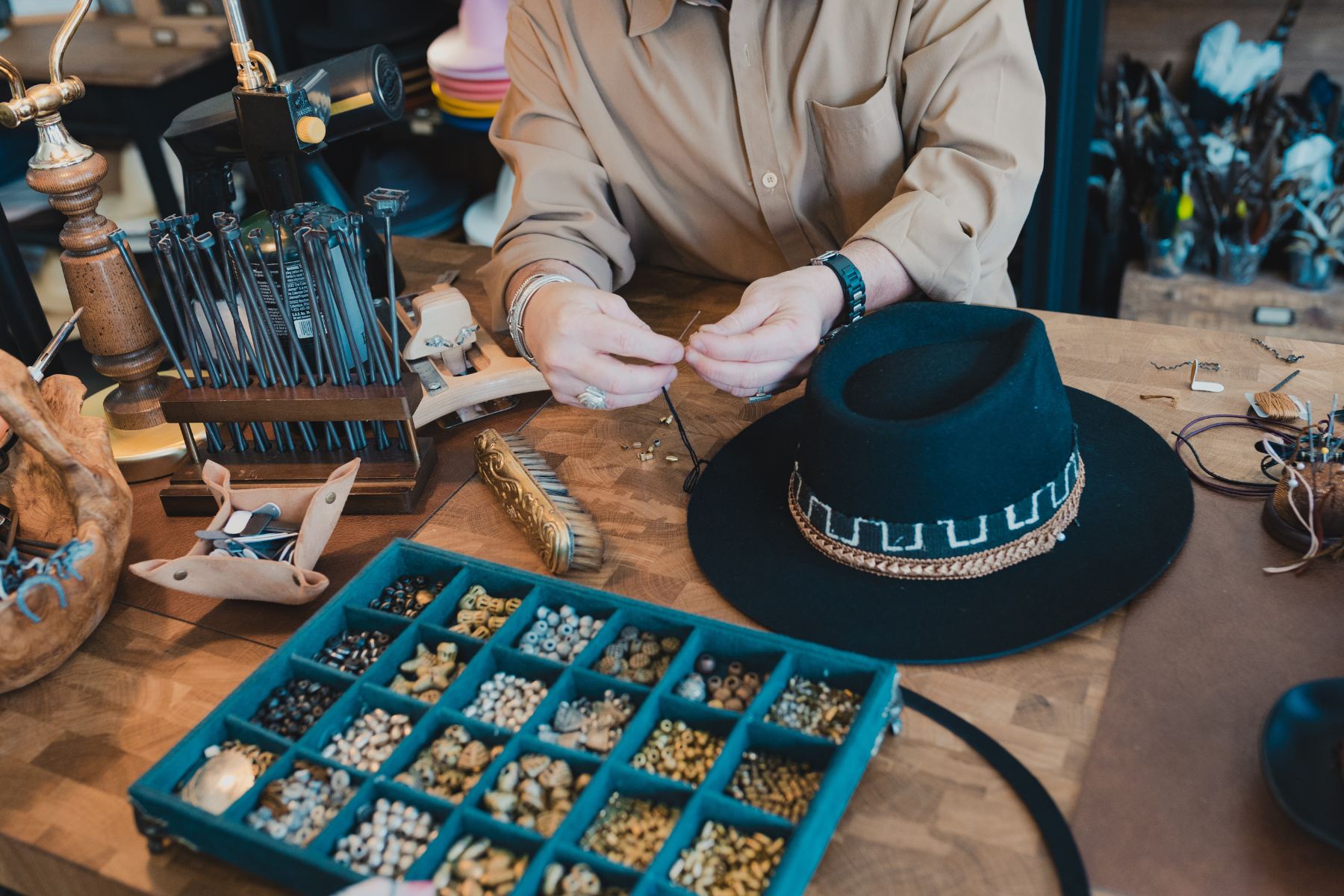 Hatter crafting personalized hats at the House of Hatters custom hat bar in Tucson, Arizona