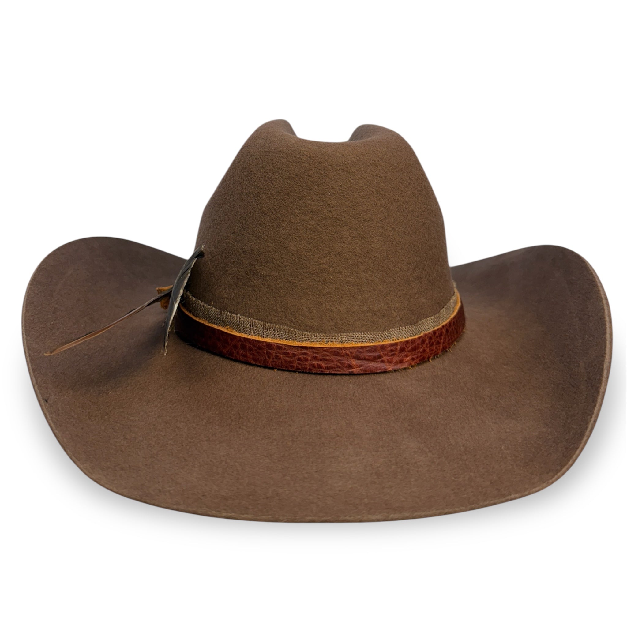 Back view of a brown felt cowboy hat showing the texture on the leather hat band.