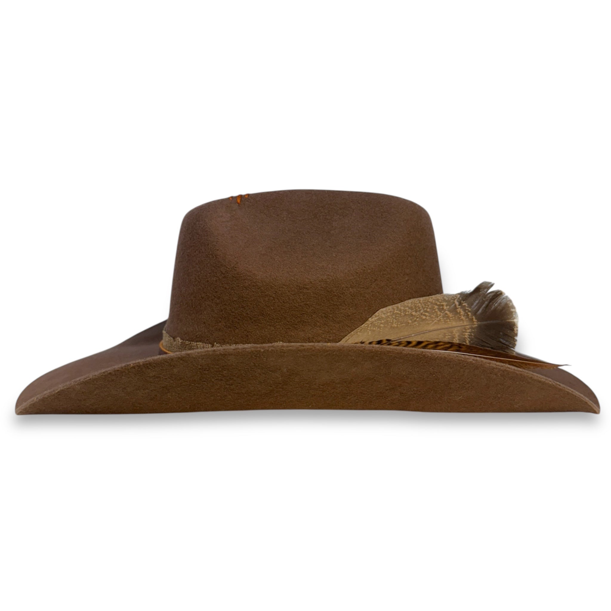 Side view of custom medium brown felt cowboy hat showing the wings of the hat and the feathers.