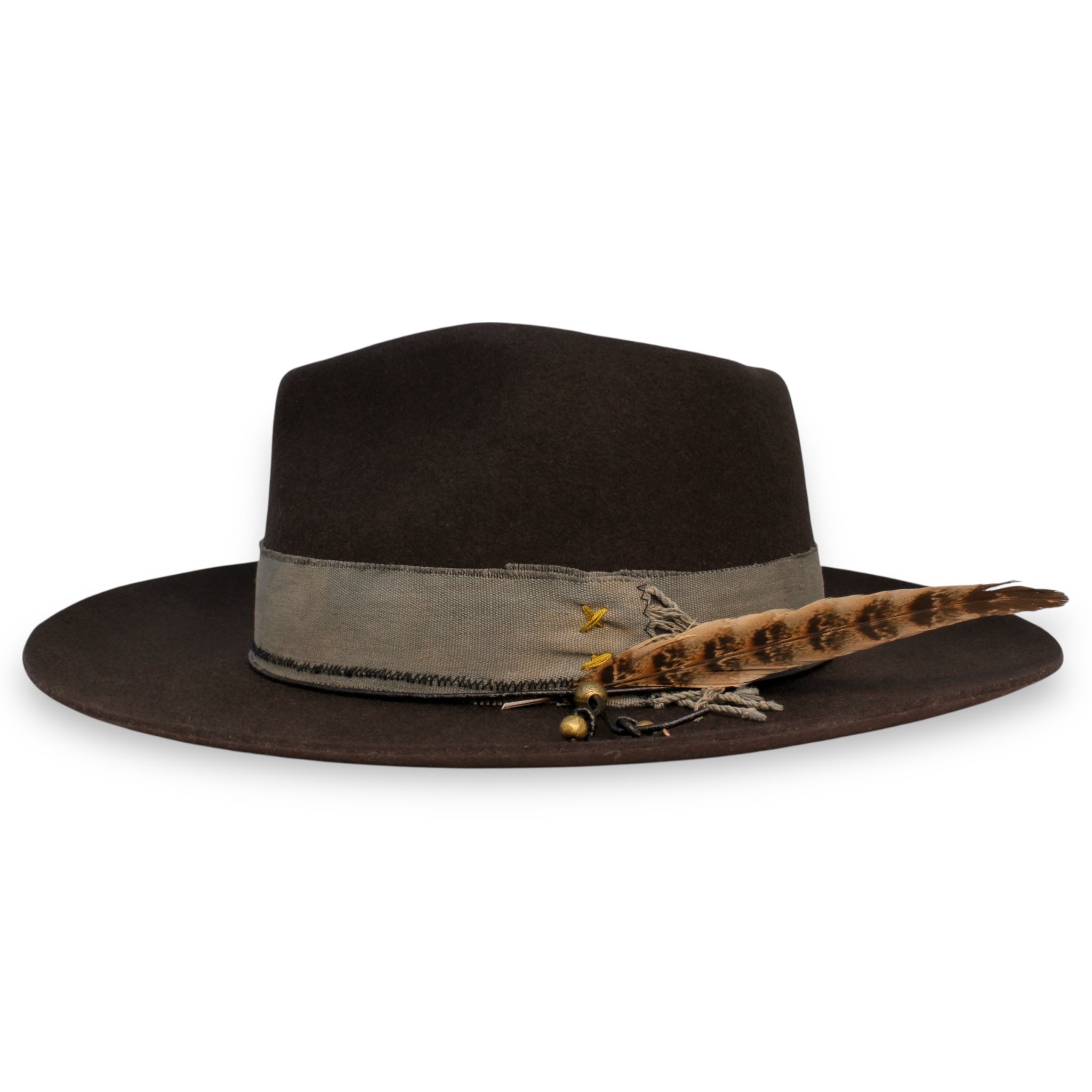 The side view of a gray fedora. This view shows off the large feather and the brass beads on the hat.