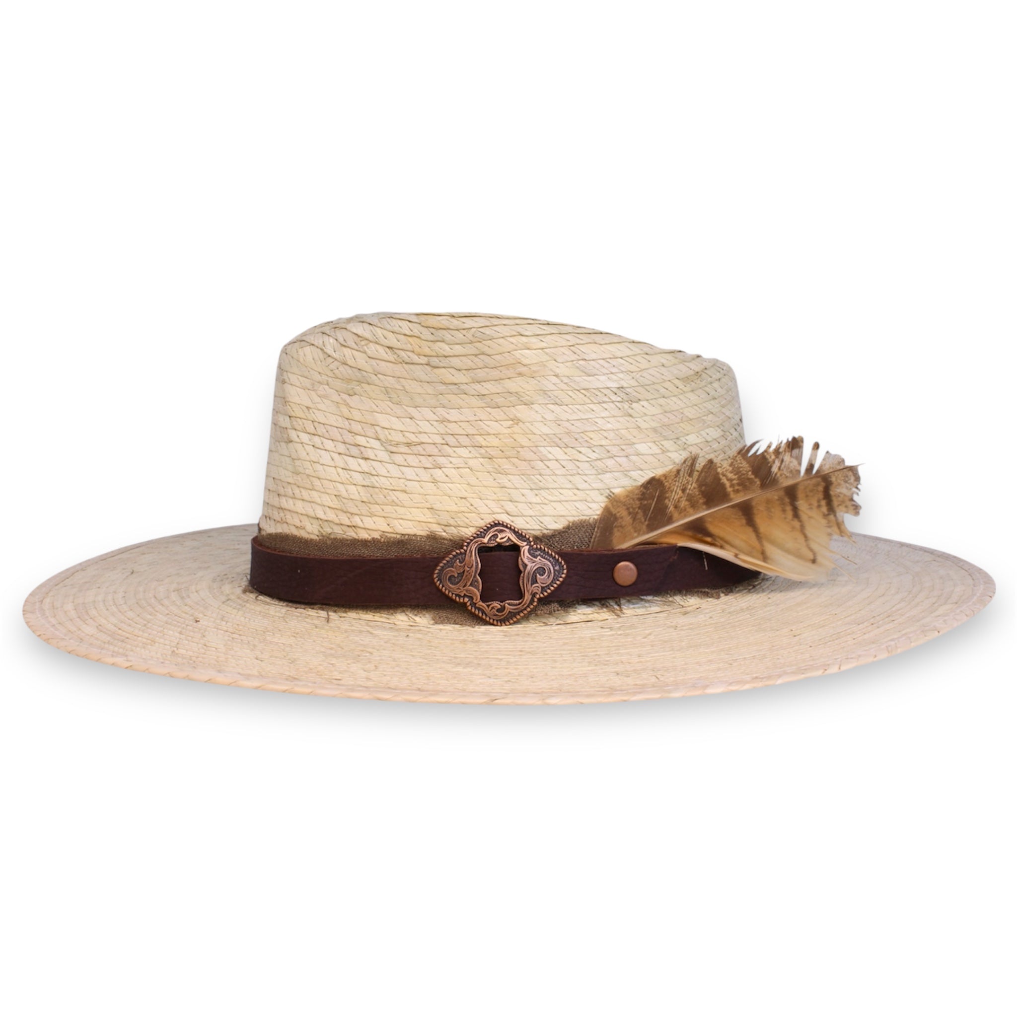 View from the side of a classy palm hat with a copper buckle on the leather band and burlap ribbon details accompanied by a feather.