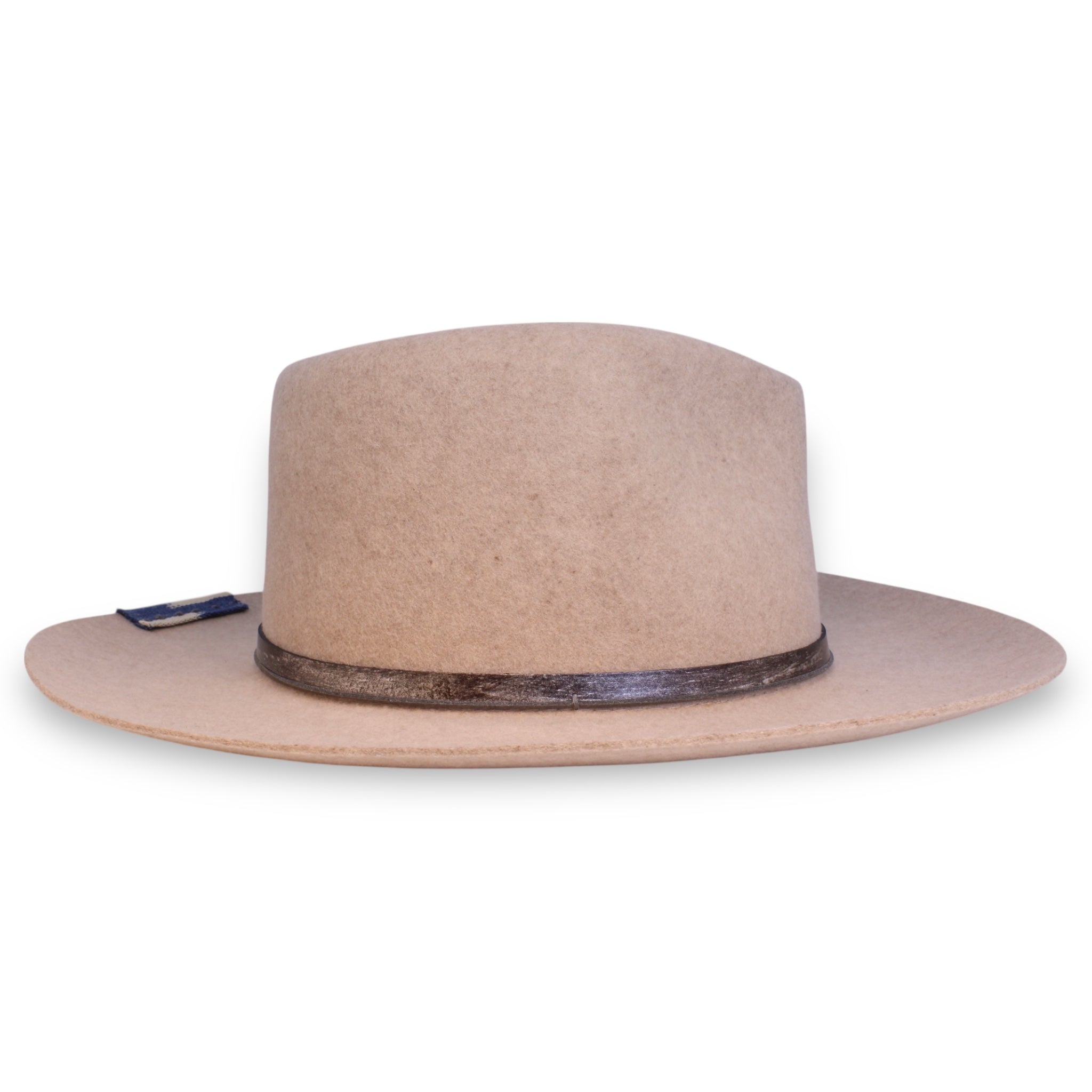 The opposite side of an oatmeal colored hat with a dark brown leather hat band and a blue textile patch.