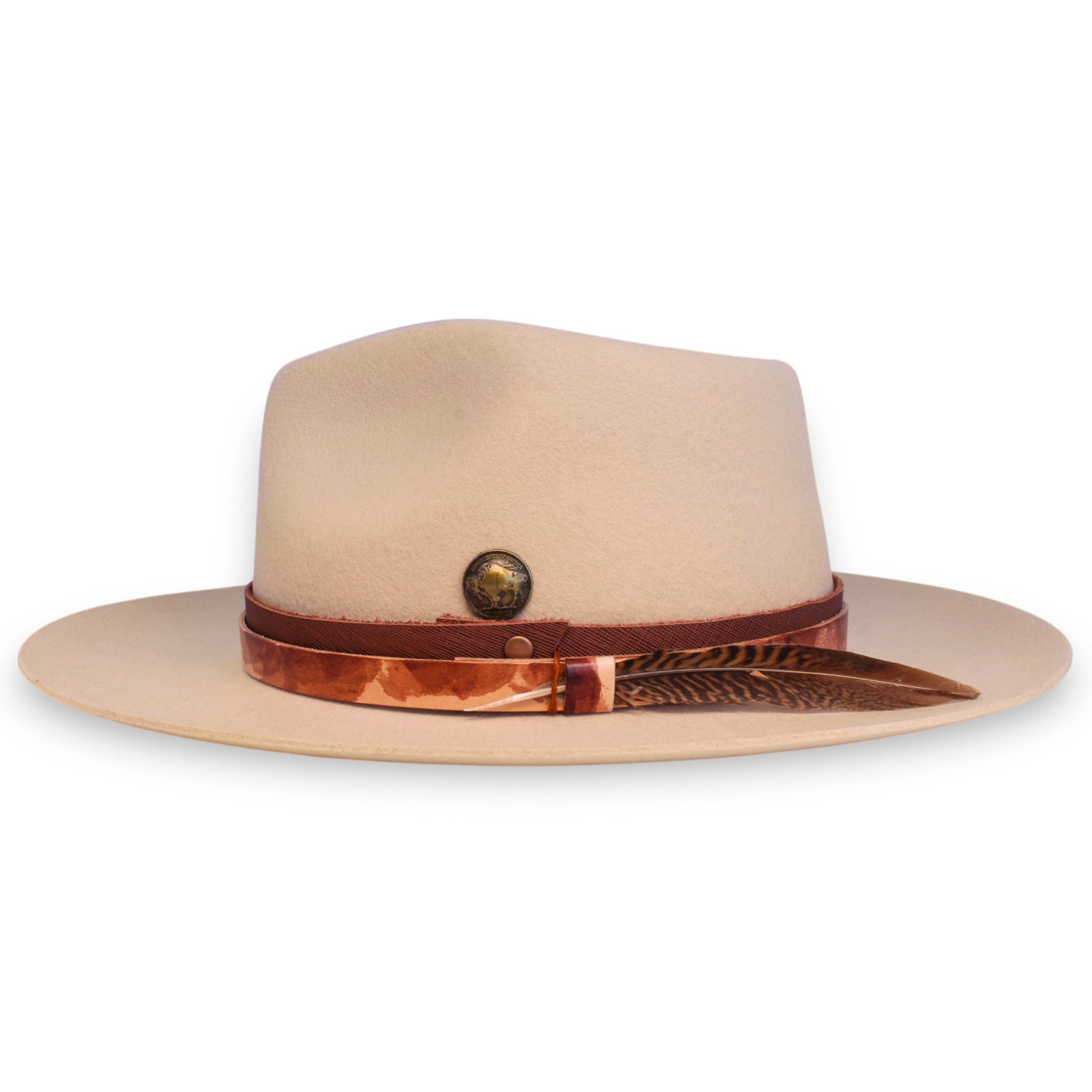 Side view of a light beige hat with red leather bands, a bronze buffalo coin, and a stripped red and black feather.