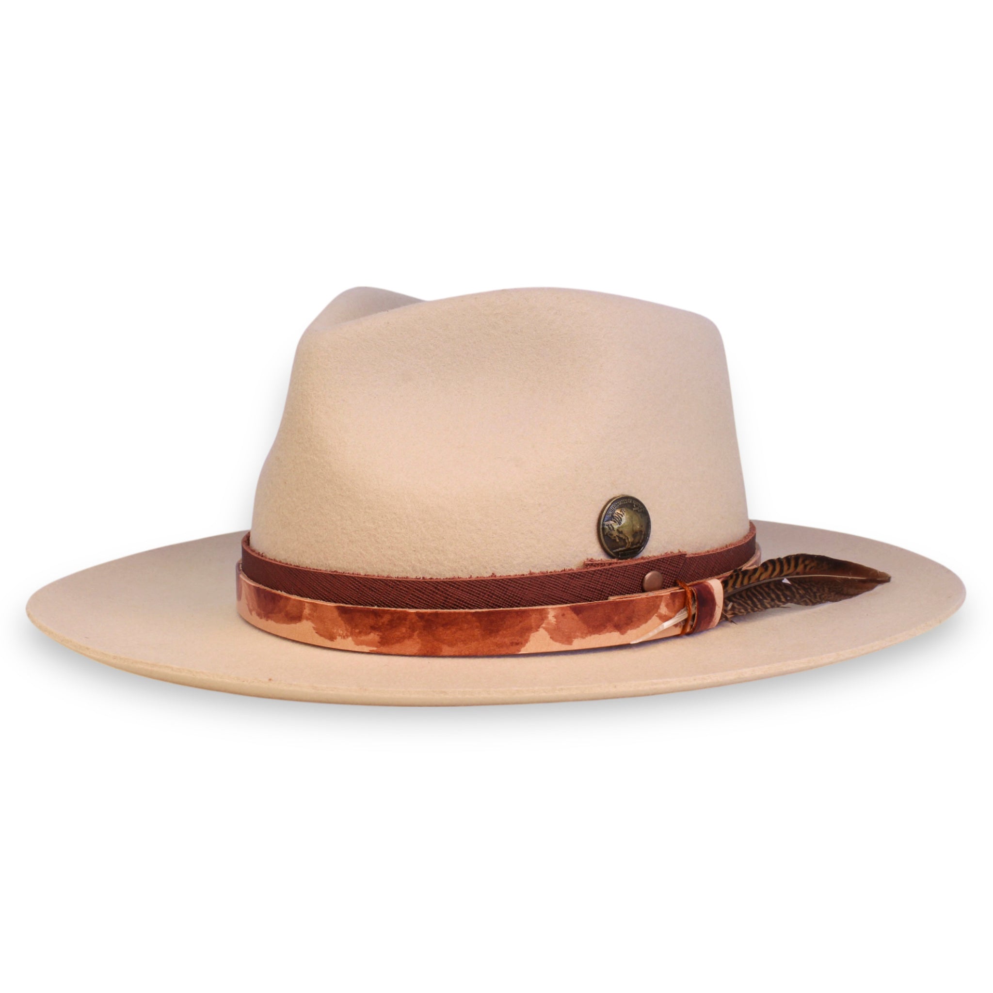A sand colored felt fedora with two leather bands, a brass buffalo coin, and a feather crafted by House of Hatters.