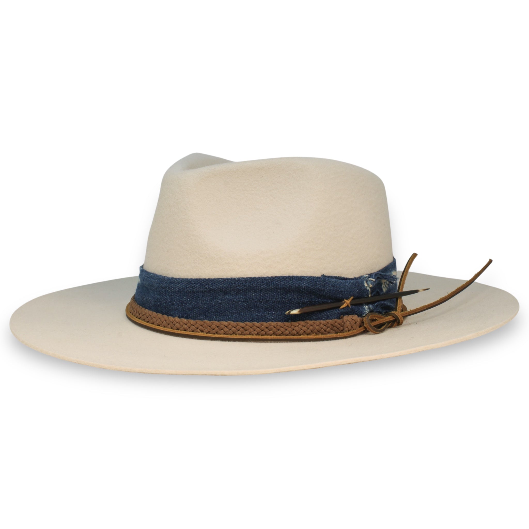A white wide pinch fedora with a wide brim featuring a blue textile band, braided cord band, a leather hat tie, and a porcupine quill created by House of Hatters.