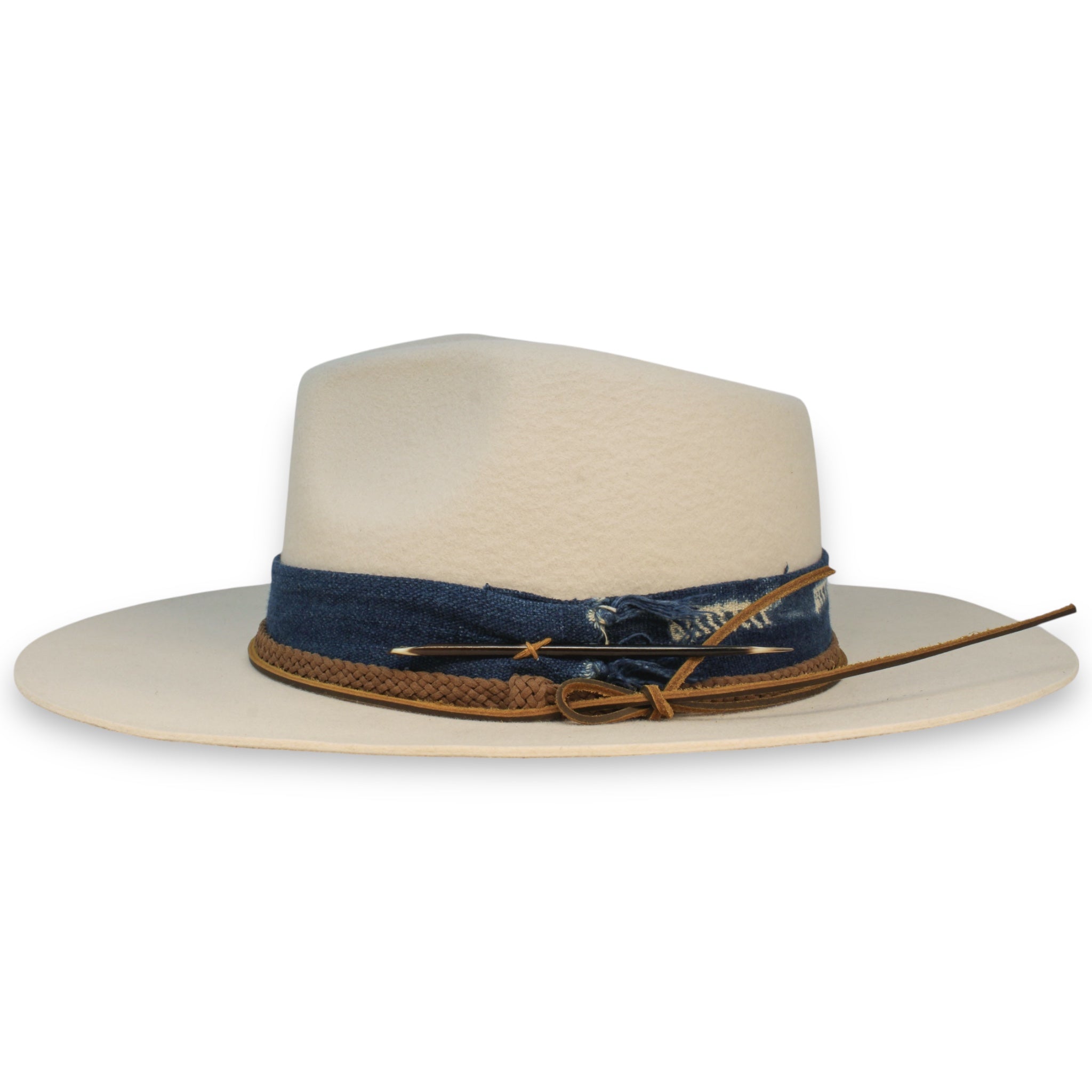 The side view of a wide brim felt fedora with a textile band and a porcupine quill.