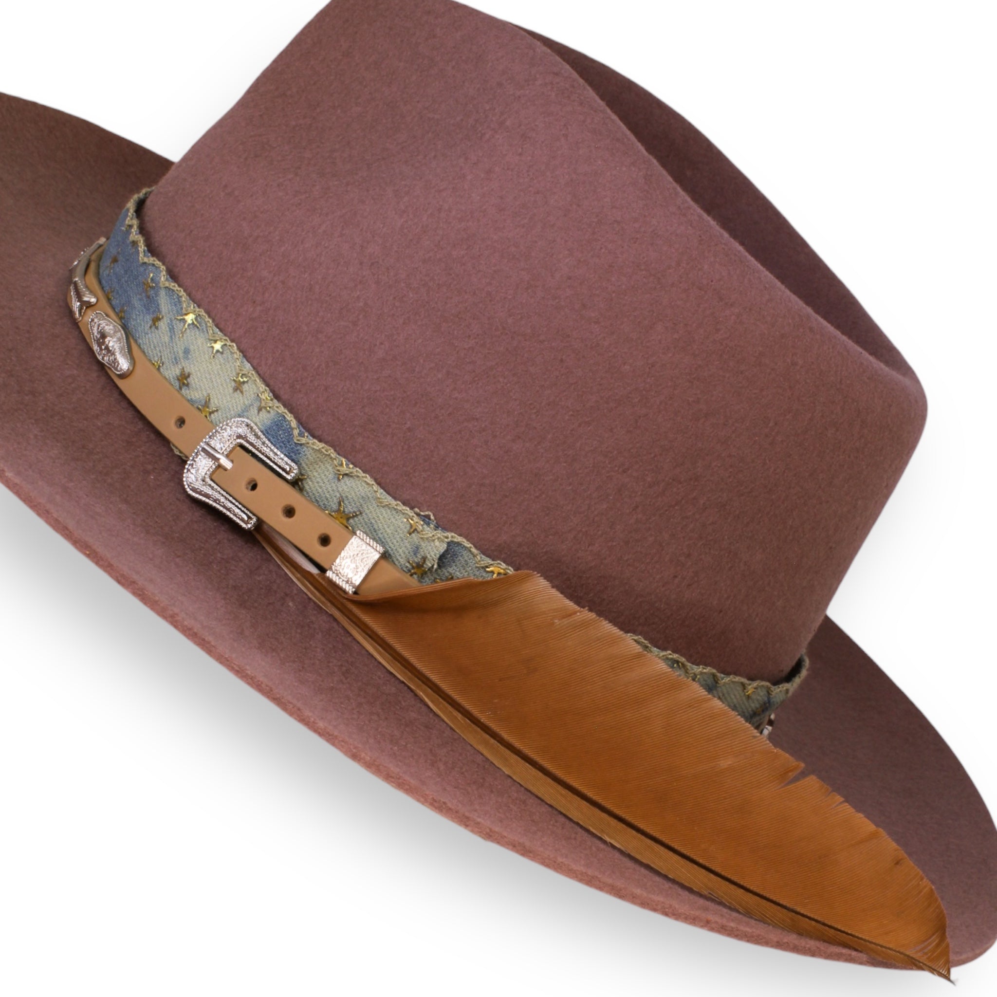 A detailed shot of the felt fedora and the silver buckle on the leather hat band. The large feather is an orange-red color.